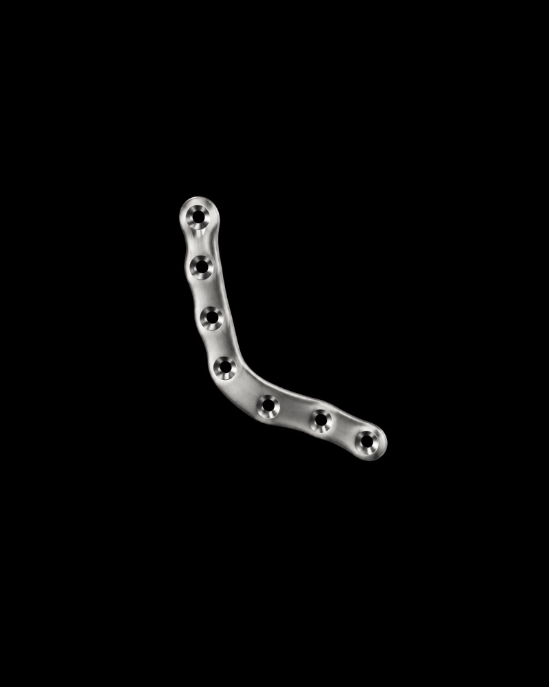 Shaped plate. A plate bent to follow the bone, such as around the cheek or the eye.